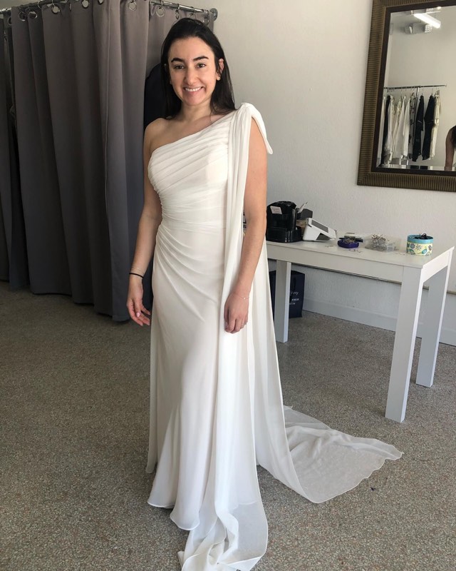 White one-shoulder chiffon gown with a train